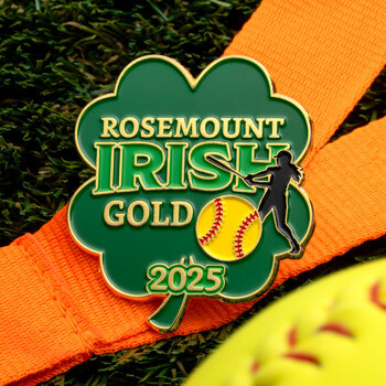 Rosemount Irish Gold 2025 clover-shaped lapel pin with a softball player silhouette and yellow softball on an orange ribbon.