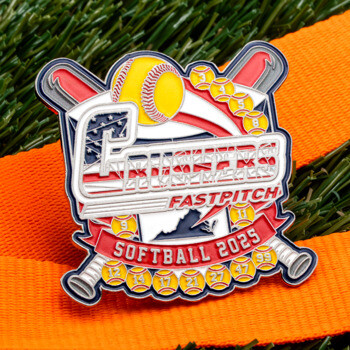 Crushers Fastpitch Softball 2025 lapel pin featuring crossed bats, a yellow softball, and the Virginia state silhouette on an orange lanyard over turf.