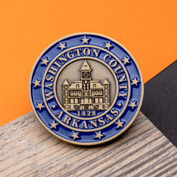 Round Washington County Arkansas challenge coin featuring a courthouse illustration, blue enamel border with stars, and 1828 date.