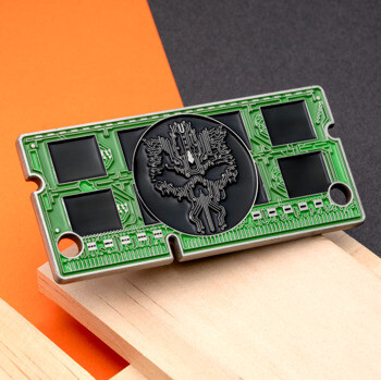 Rectangular green and black circuit board challenge coin featuring a central skull motif with circuit traces.