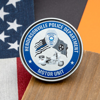 Hendersonville Police Department Motor Unit challenge coin featuring a motorcycle, flags, and a police badge design.