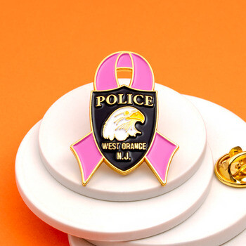 West Orange Police pink ribbon lapel pin featuring an eagle badge emblem with gold trim.