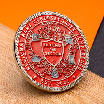Red and silver Regional Bank Cybersecurity Conference challenge coin featuring a central shield reading Defend the Sector surrounded by tech icons.