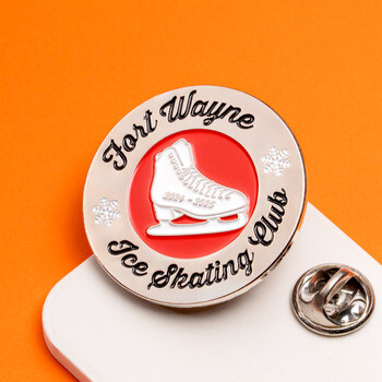 Fort Wayne Ice Skating Club round enamel lapel pin featuring a white ice skate on a red center with snowflakes and silver backing clutch.