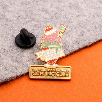 San Francisco Bay Area Curling Club enamel lapel pin shaped like an ice cream sundae topped with a curling stone.