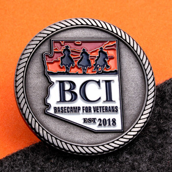 Antique silver challenge coin featuring rope edge and Arizona emblem with horseback riders for BCI Basecamp for Veterans.